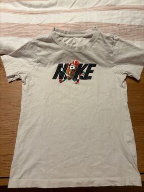 Nike White Tee with Playful Football Character Graphic